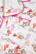 White cowgirl country print pajamas set from Mommas Hive, soft loungewear with comfortable polyester and elastane blend.