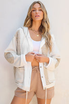 Light blue quilted textured patchwork loose fit hooded jacket by Mommas Hive, displayed on a hanger with visible stitching details.