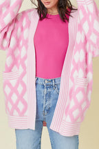 Pink rhombus pattern knit open front cardigan with pockets from Mommas Hive, made of viscose, polyester, and polyamide.