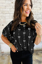 Black bow print puff short sleeve top by Mommas Hive, lightweight polyester blouse with feminine puff sleeves and bow pattern.