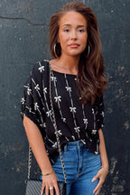 Black bow print puff short sleeve top by Mommas Hive, featuring a stylish design and comfortable fit, made from lightweight polyester fabric.