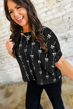 Black bow print puff short sleeve top from Mommas Hive, stylish blouse with ruffled sleeves and lightweight polyester fabric.