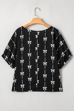Black bow print puff short sleeve top by Mommas Hive, stylish blouse with short sleeves and a playful bow design.