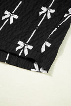 Black bow print puff short sleeve top by Mommas Hive, lightweight polyester blouse with a chic bow design and puff sleeves.