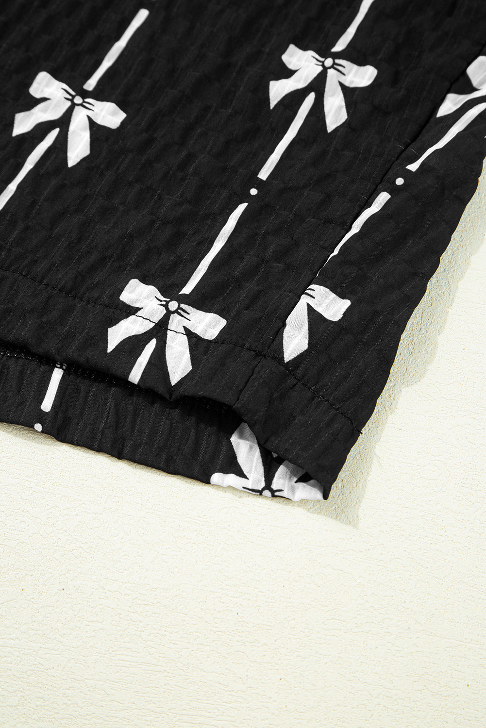 Black bow print puff short sleeve top by Mommas Hive, lightweight polyester blouse with a chic bow design and puff sleeves.