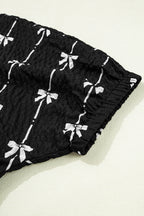 Black Bow Print Puff Short Sleeve Top by Mommas Hive, featuring a stylish bow pattern and lightweight polyester fabric.