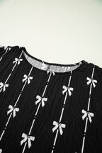 Black bow print puff short sleeve top by Mommas Hive, lightweight polyester blouse with feminine bow detail.