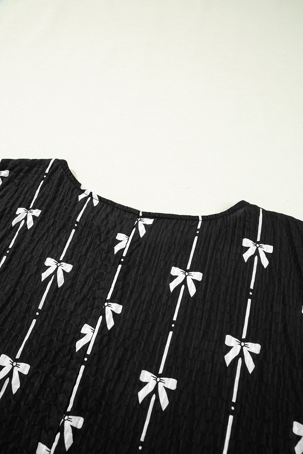 Black bow print puff short sleeve top by Mommas Hive, lightweight polyester blouse with a stylish bow detail and puffed sleeves.