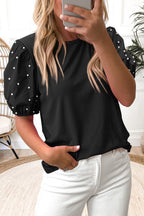 Black ribbed pearl beaded puff sleeve top by Mommas Hive, featuring elegant puff sleeves and textured fabric.