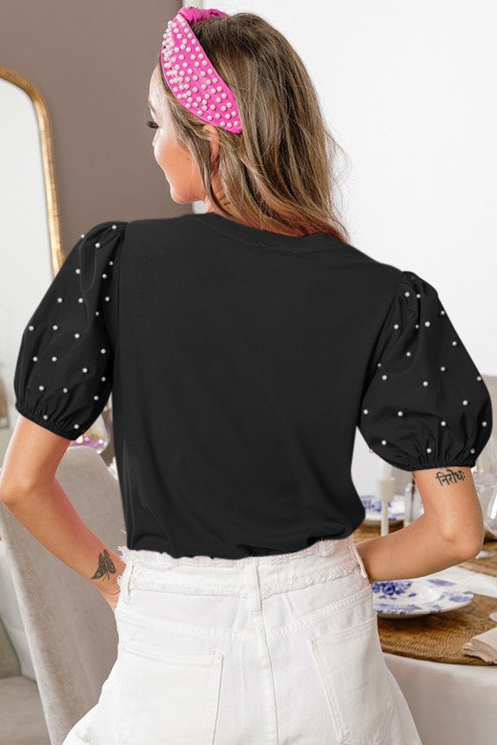 Black ribbed pearl beaded puff sleeve top by Mommas Hive, made from viscose and elastane, featuring textured fabric and decorative pearl details.