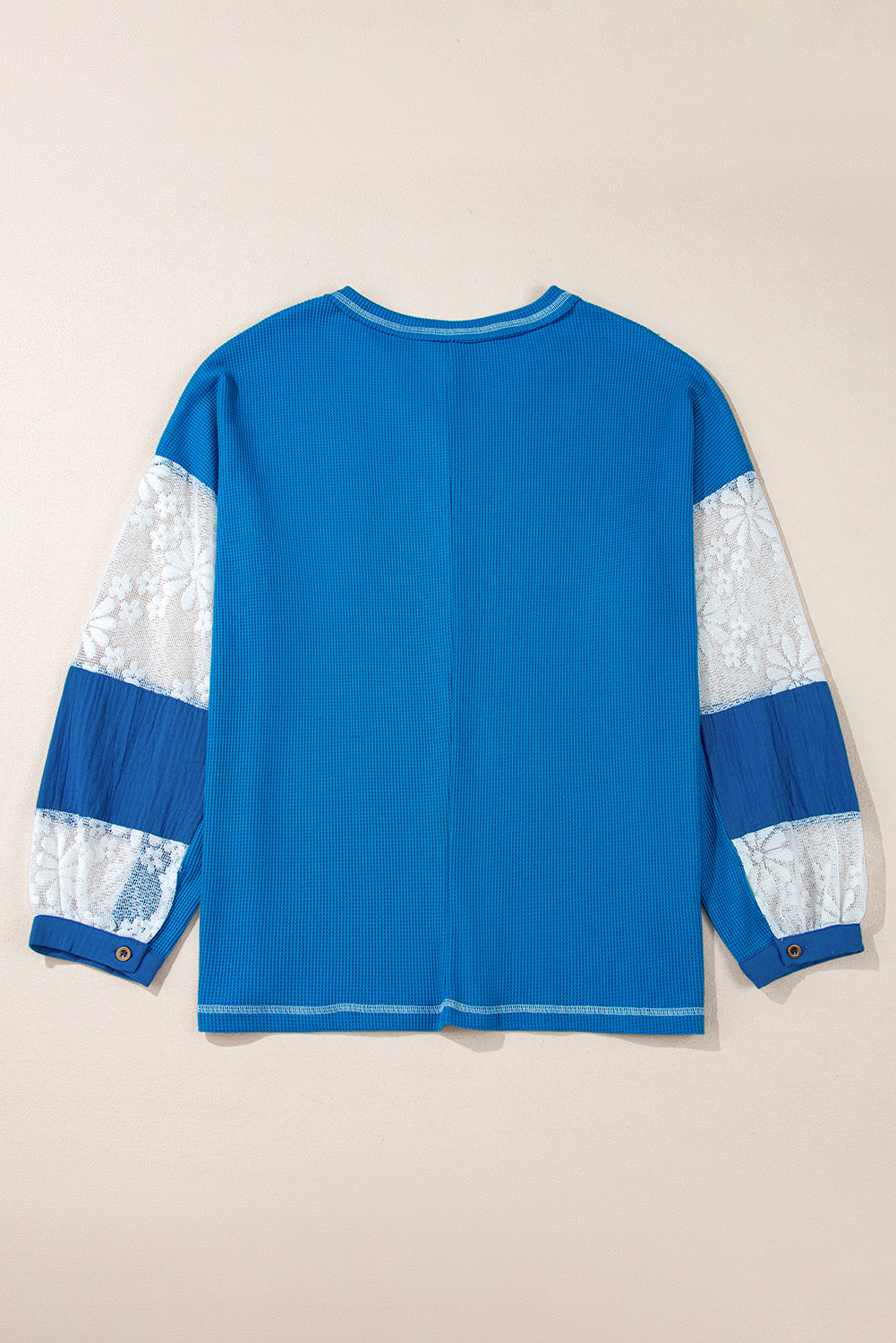 Mommas Hive Bonbon lace floral patchwork blouse with V-neck, rib knit fabric, long sleeves, and stitch detailing.