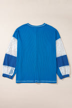 Mommas Hive Bonbon lace floral patchwork blouse with V-neck, rib knit fabric, long sleeves, and stitch detailing.