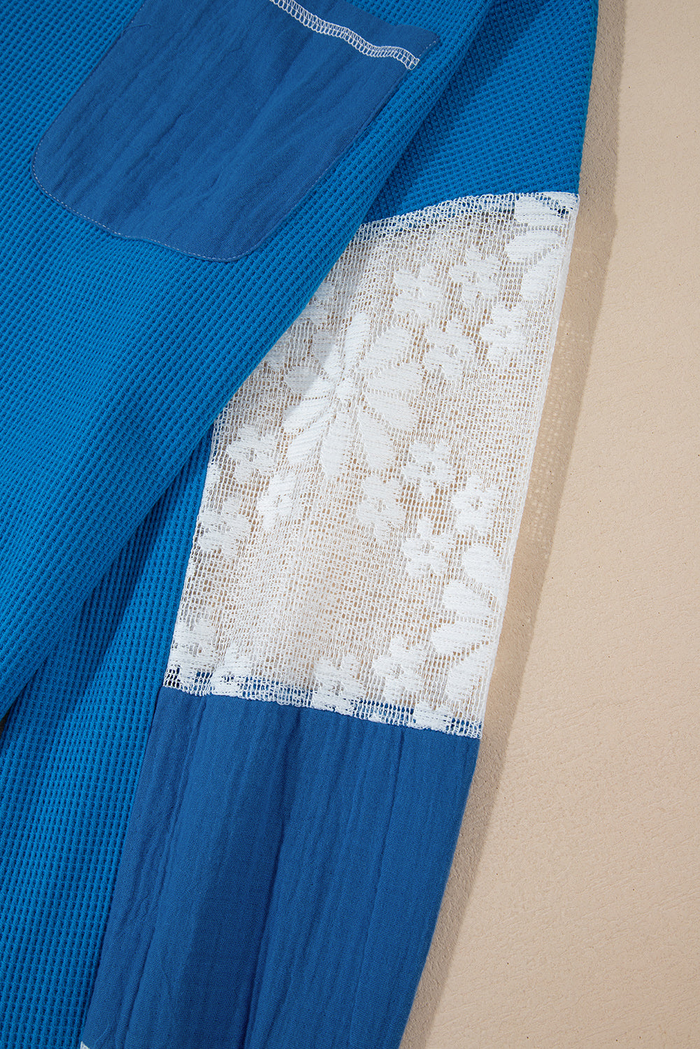 Mommas Hive Bonbon lace floral patchwork blouse with V-neck, rib knit, long sleeves, and stitched details.