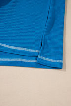 Mommas Hive Bonbon lace floral patchwork blouse with V-neck, rib knit fabric, long sleeves, and stitching details.