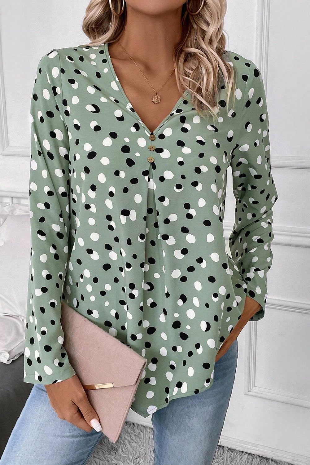 Green polka dot print blouse with button front and V-neck, by Mommas Hive, made of lightweight polyester.