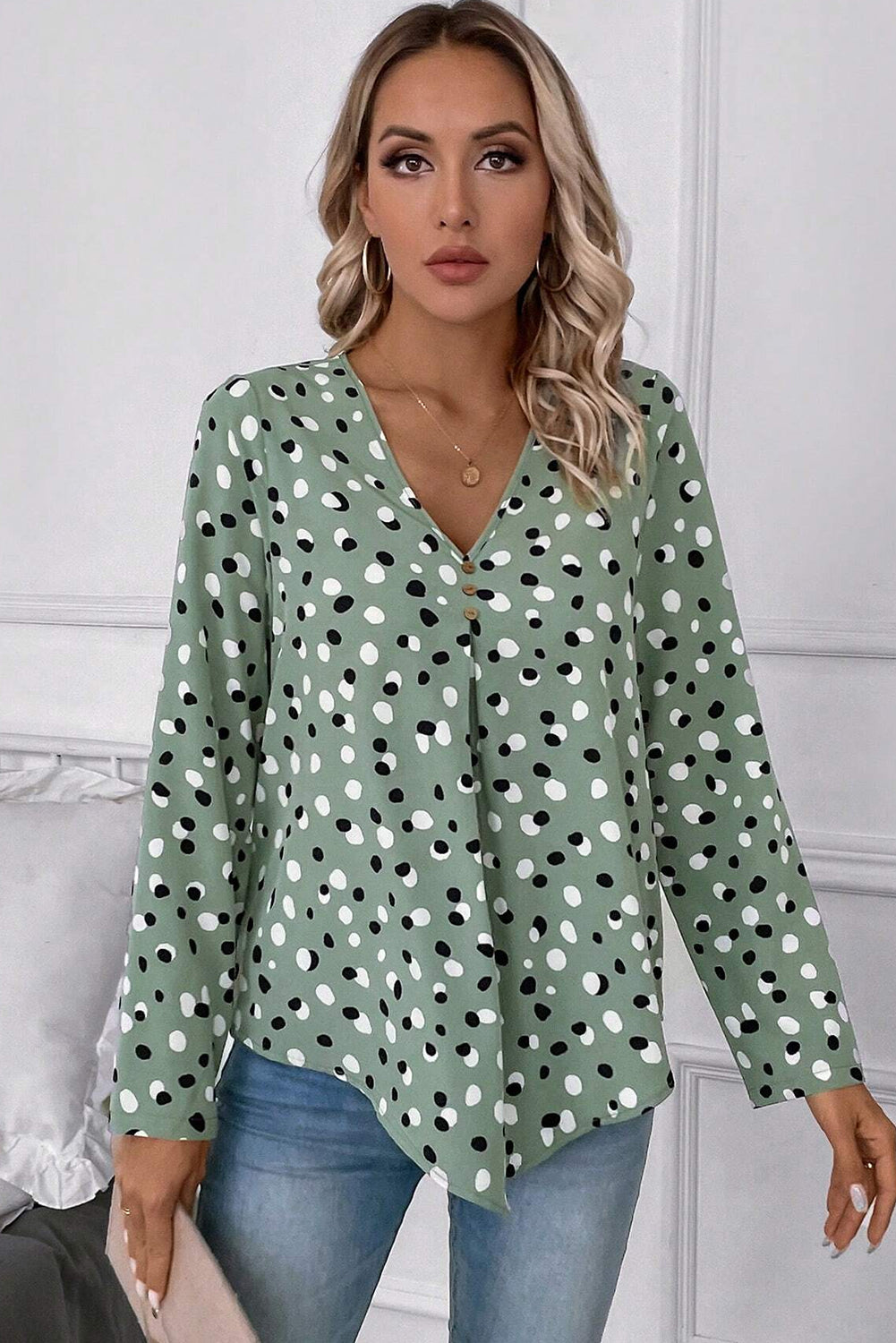 Green polka dot print blouse from Mommas Hive with button front and V-neck, made of lightweight polyester fabric.