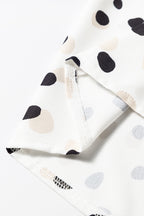 Green polka dot print blouse from Mommas Hive with button front and V-neck, made of lightweight polyester.