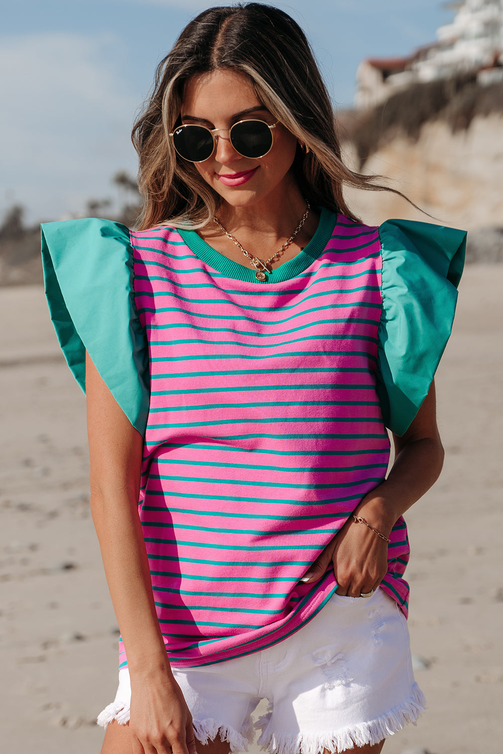 Pink stripe colorblock blouse by Mommas Hive with ruffled sleeves and crew neck, made of cotton and elastane, displayed on a hanger.