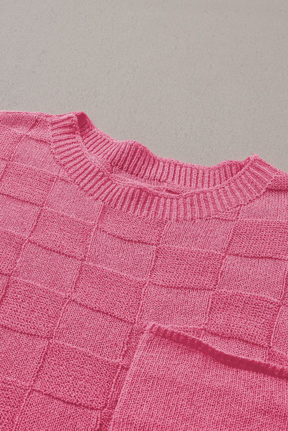 Bright pink lattice textured knit short sleeve sweater from Mommas Hive, showcasing a stylish, cozy top with a vibrant pattern.