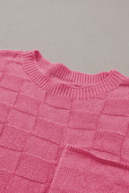 Bright pink lattice textured knit short sleeve sweater from Mommas Hive, showcasing a stylish, cozy top with a vibrant pattern.
