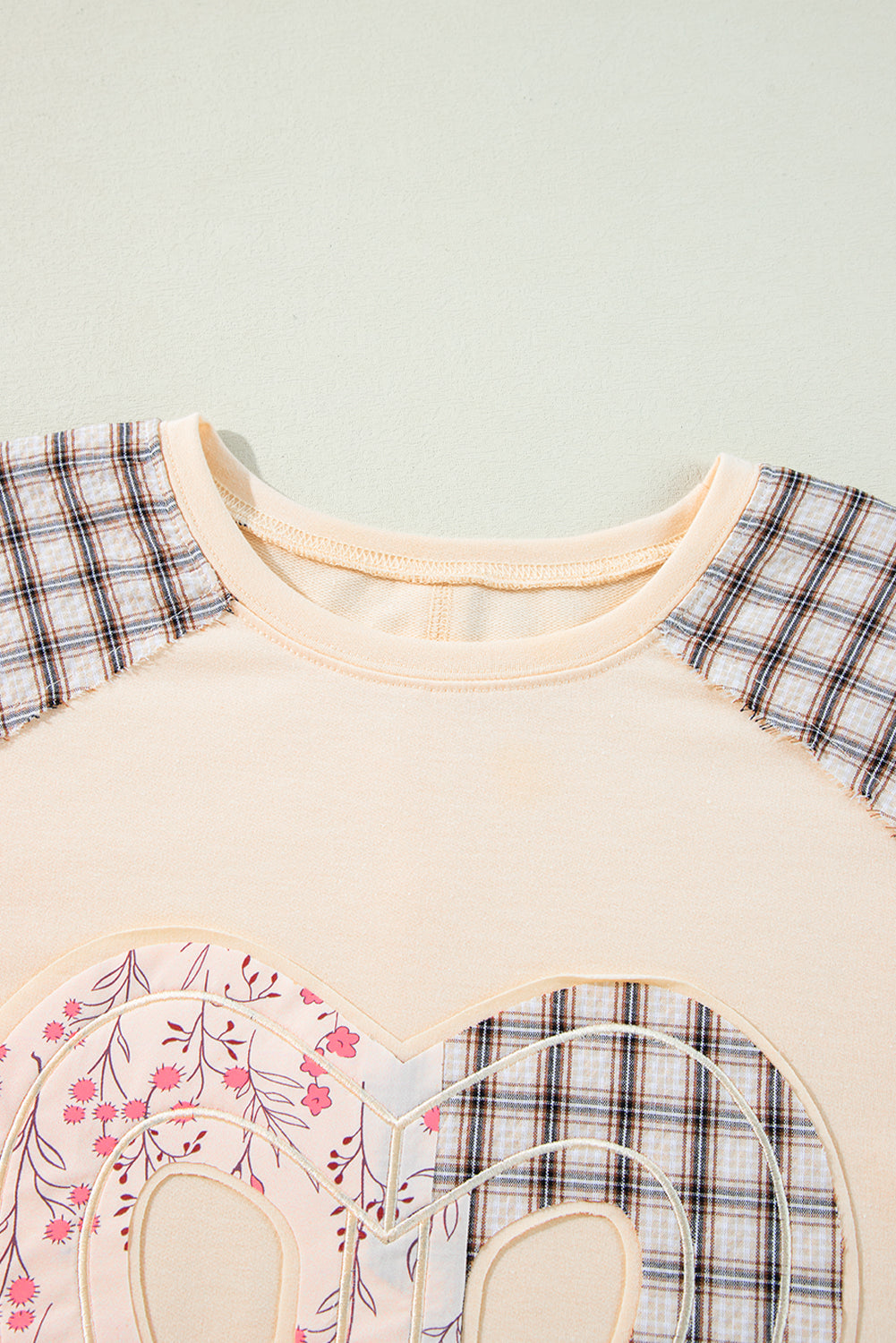 Beige plaid floral peace heart graphic wide long sleeve top by Mommas Hive, featuring a relaxed fit and floral print design.