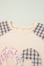Beige plaid floral peace heart graphic wide long sleeve top by Mommas Hive, featuring a relaxed fit and floral print design.