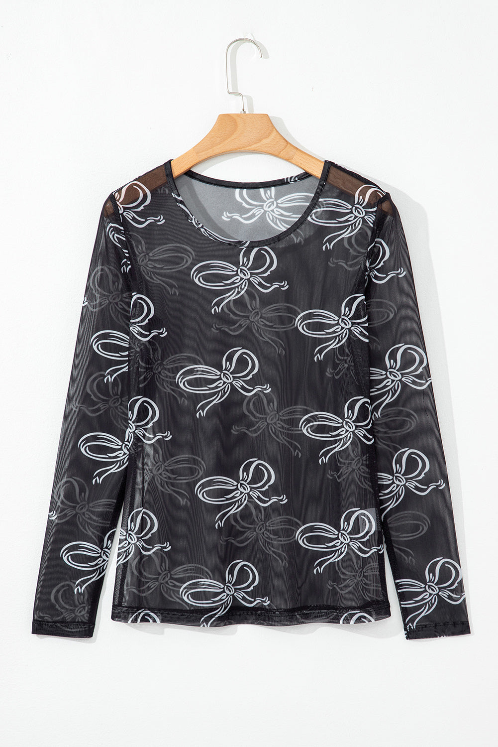 Black long sleeve mesh top with a round neck and bow print by Mommas Hive, featuring a fitted design and sheer fabric.