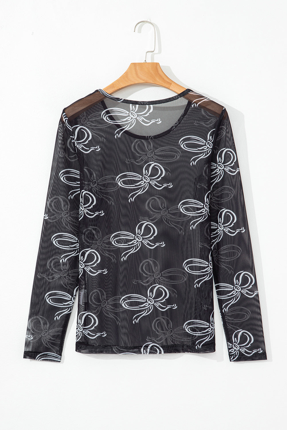 Black long sleeve mesh top with round neck and bow print from Mommas Hive, featuring a fitted design and sheer fabric.