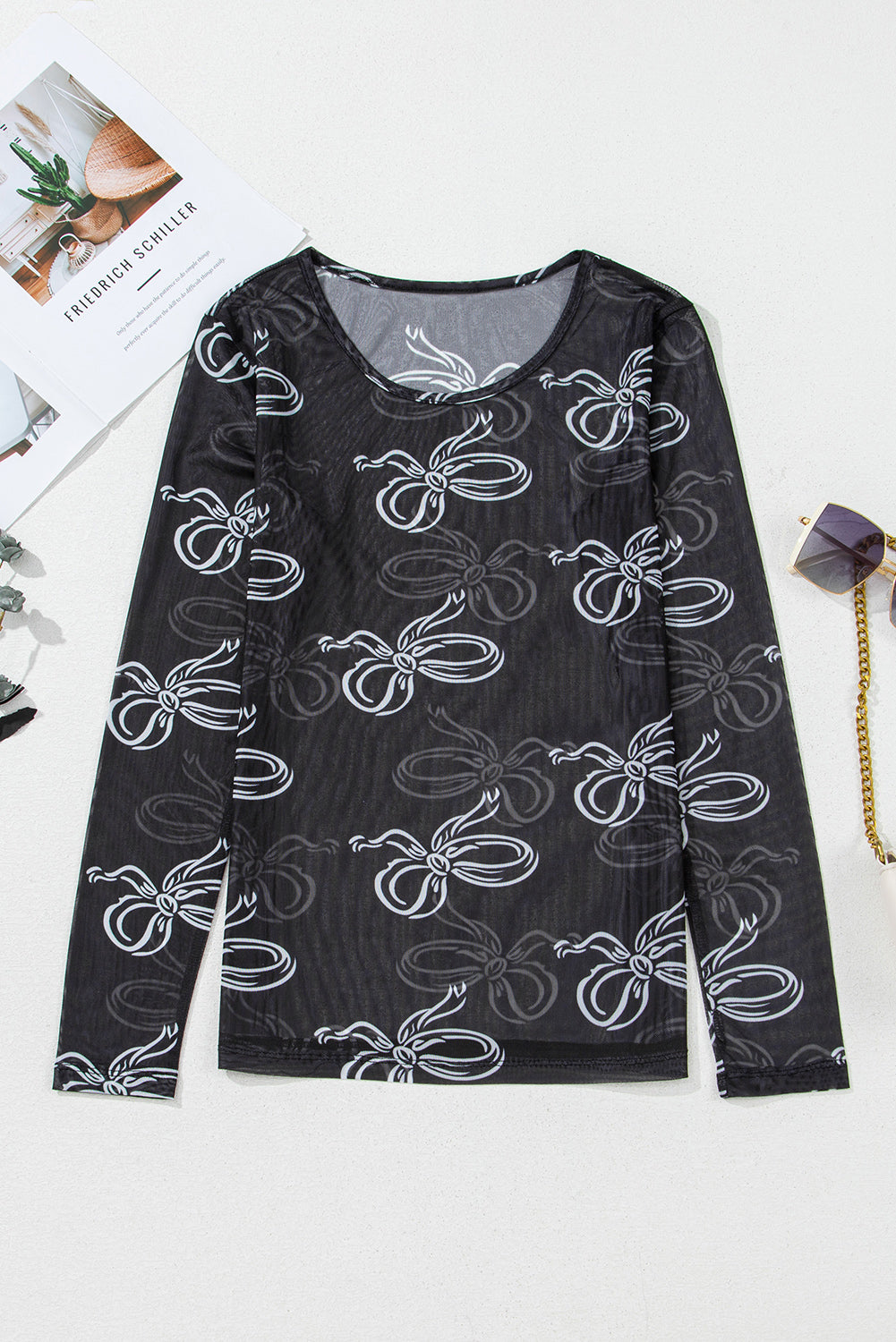 Black round neck long sleeve mesh top with bow print from Mommas Hive, featuring a fitted design and sheer fabric.