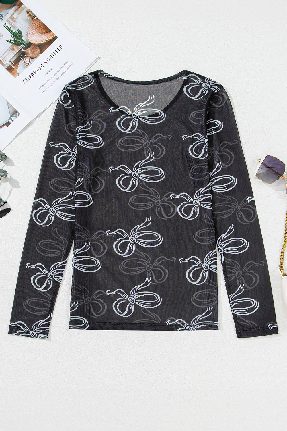 Black round neck mesh top with bow print from Mommas Hive, long sleeve design made of polyester and elastane.