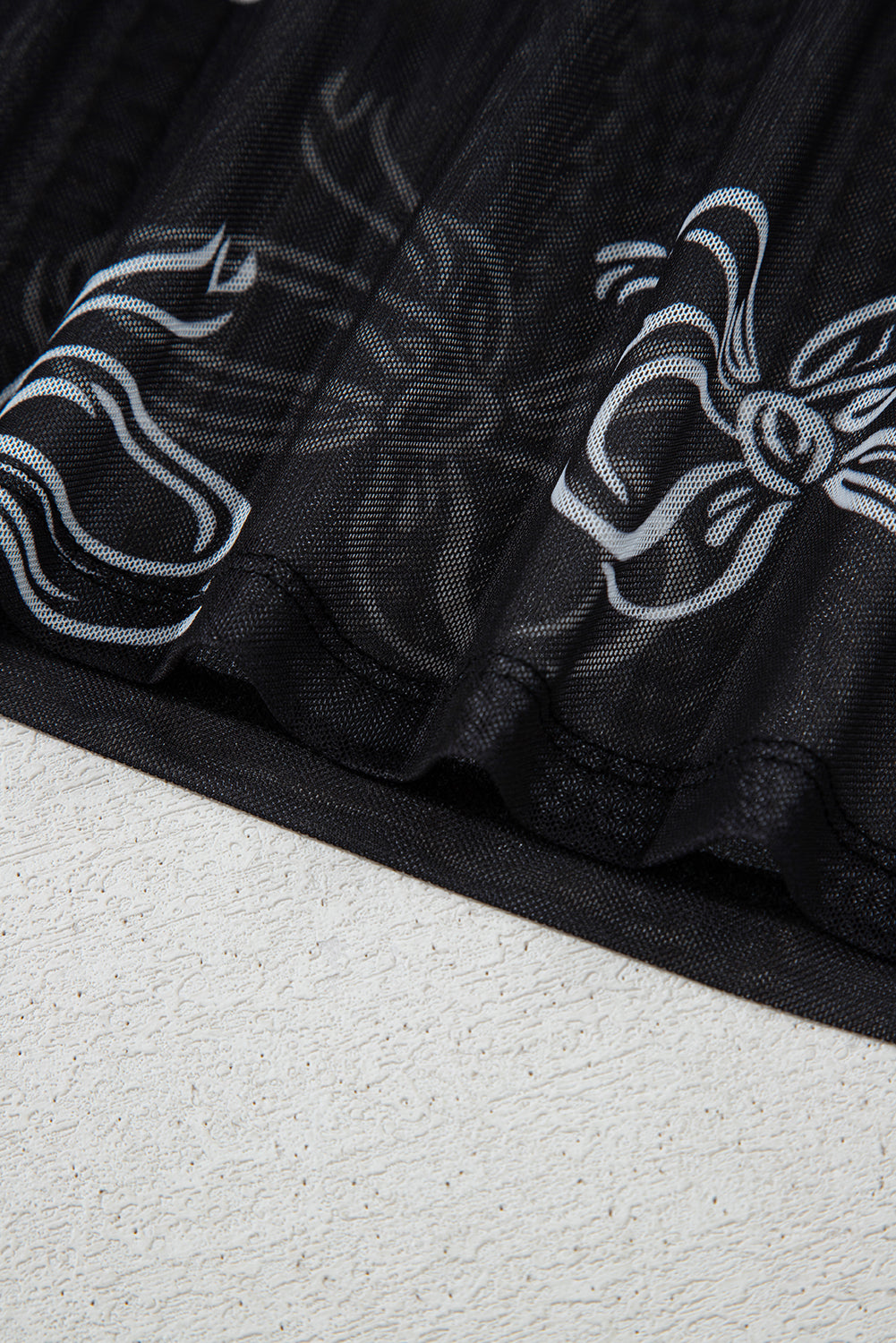 Black long sleeve mesh top with bow print from Mommas Hive, featuring a round neckline and fitted style.