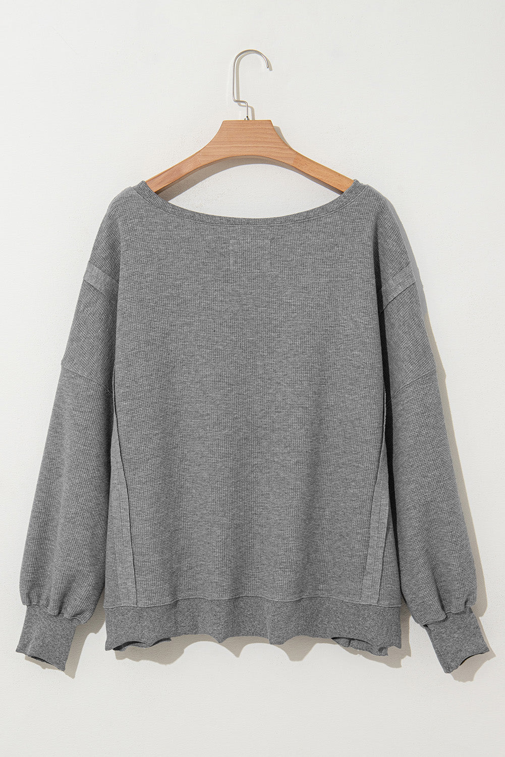 Gray waffle knit oversized top with bishop sleeves and split design, made by Mommas Hive, long sleeve fashion for women.