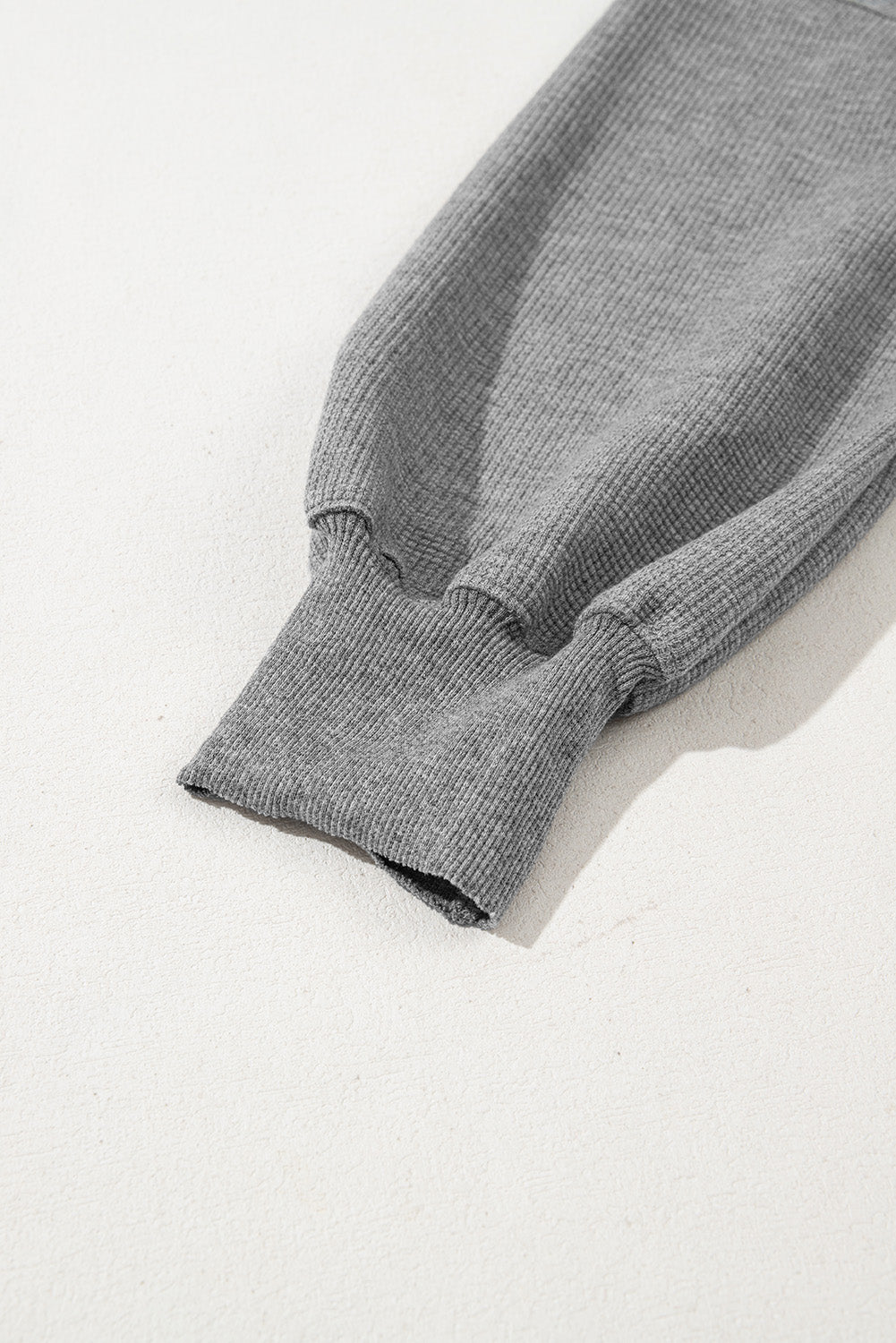 Gray waffle knit bishop sleeve oversized top by Mommas Hive, featuring split design and long sleeves.