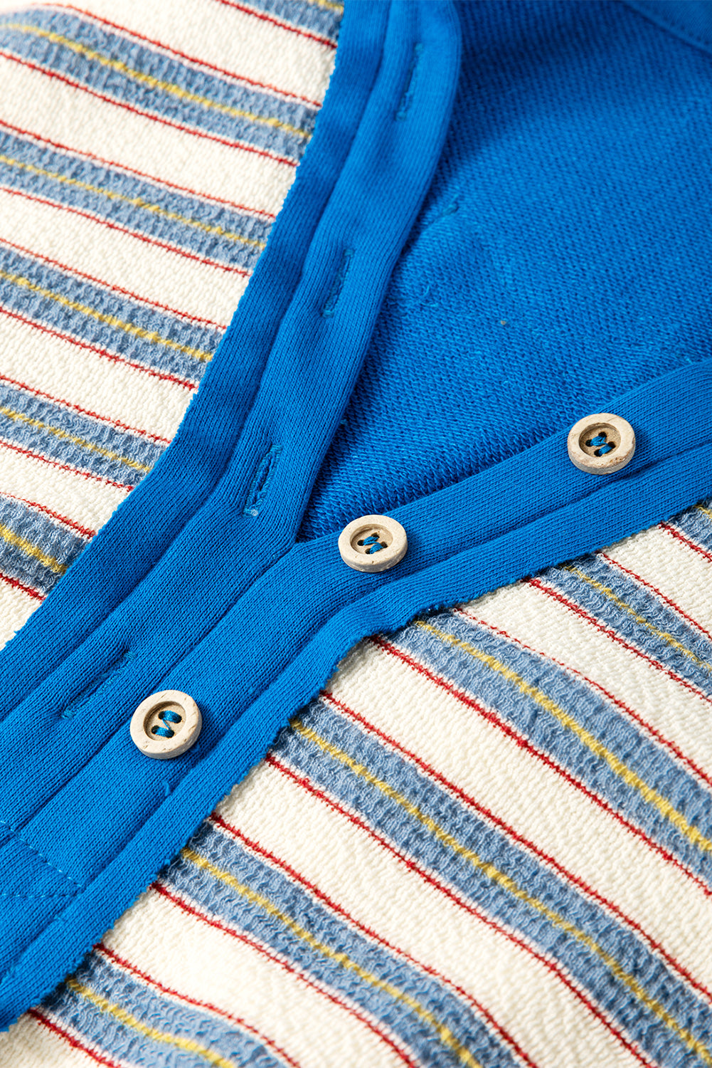 Red stripe long sleeve top by Mommas Hive featuring a V-neck, buttoned collar, and drop shoulder design.