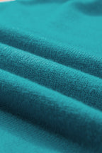 Mommas Hive turquoise knitted sweater T-shirt with contrast flutter sleeves, short sleeve top made of viscose, polyester, and polyamide.