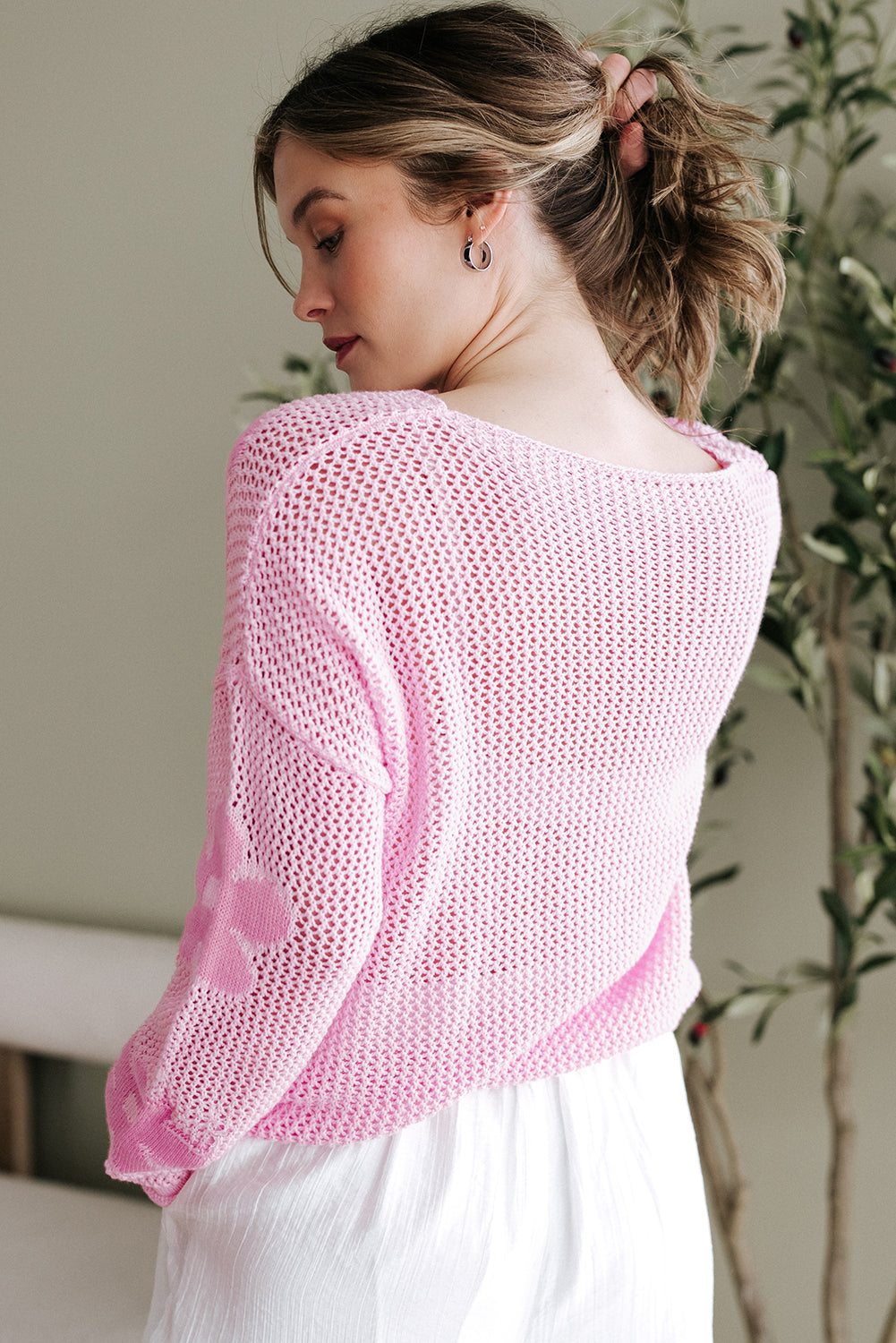 Light pink knitted sweater with large floral hollow design, drop shoulder style, from Mommas Hive, made of acrylic and cotton.
