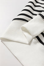 Black stripe raglan sleeve loose sweatshirt by Mommas Hive featuring side slits and a relaxed fit, made of cotton and elastane.