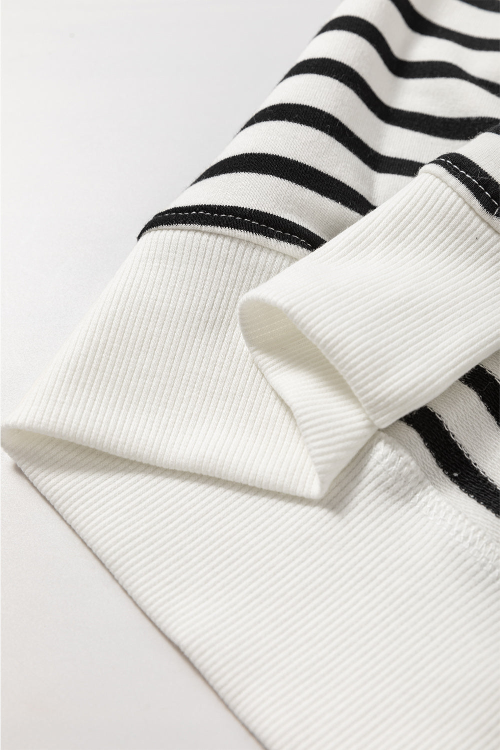 Black stripe raglan sleeve loose sweatshirt by Mommas Hive featuring side slits and a relaxed fit, made of cotton and elastane.