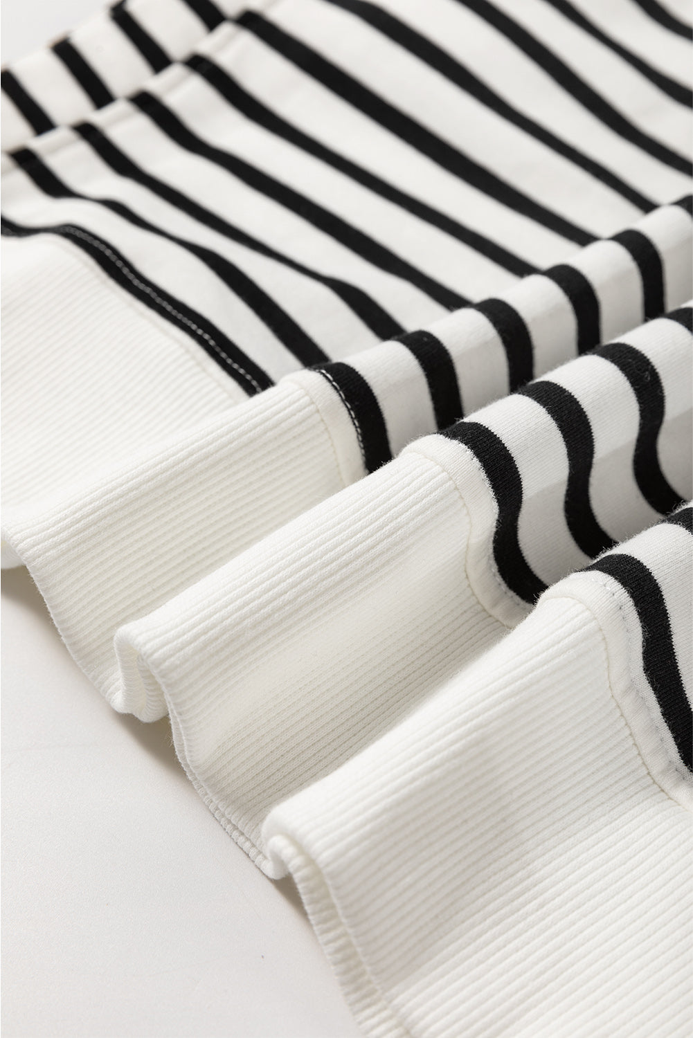Black Stripe Raglan Sleeve Loose Sweatshirt by Mommas Hive featuring side slits and relaxed fit, made from cotton and elastane blend.