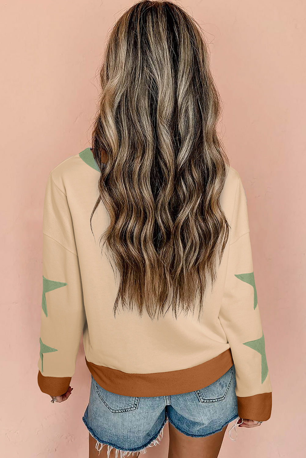 Light pink oversized sweatshirt with star patchwork and exposed seams from Mommas Hive, featuring a cozy, stylish sweatshirt design.