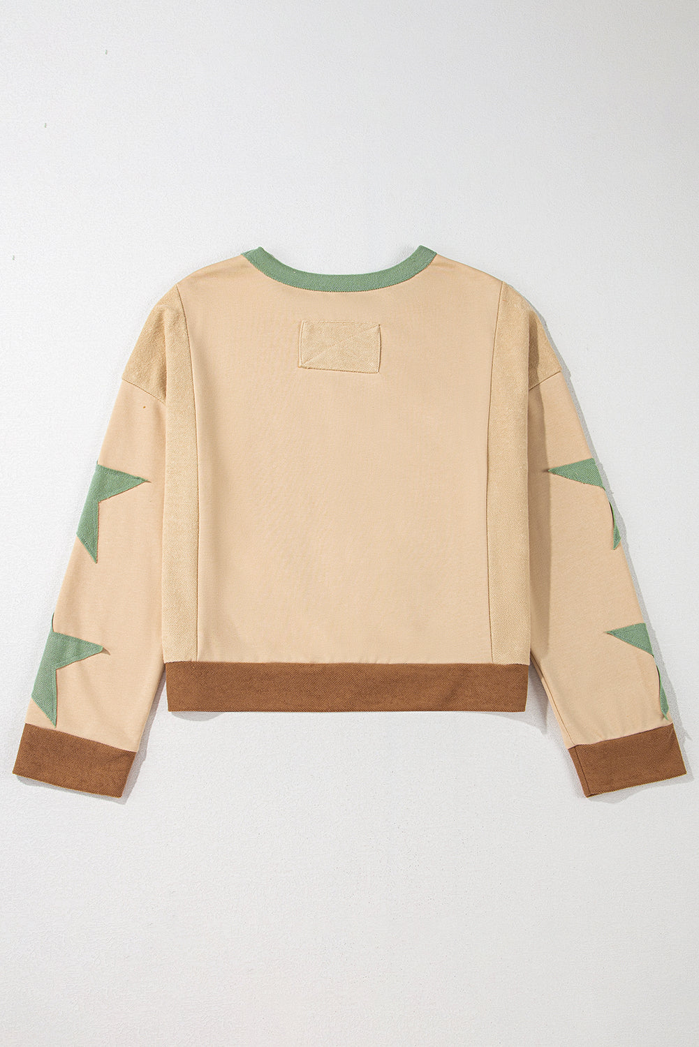 Light pink oversized sweatshirt with star patchwork and exposed seams from Mommas Hive, made of polyester and cotton.