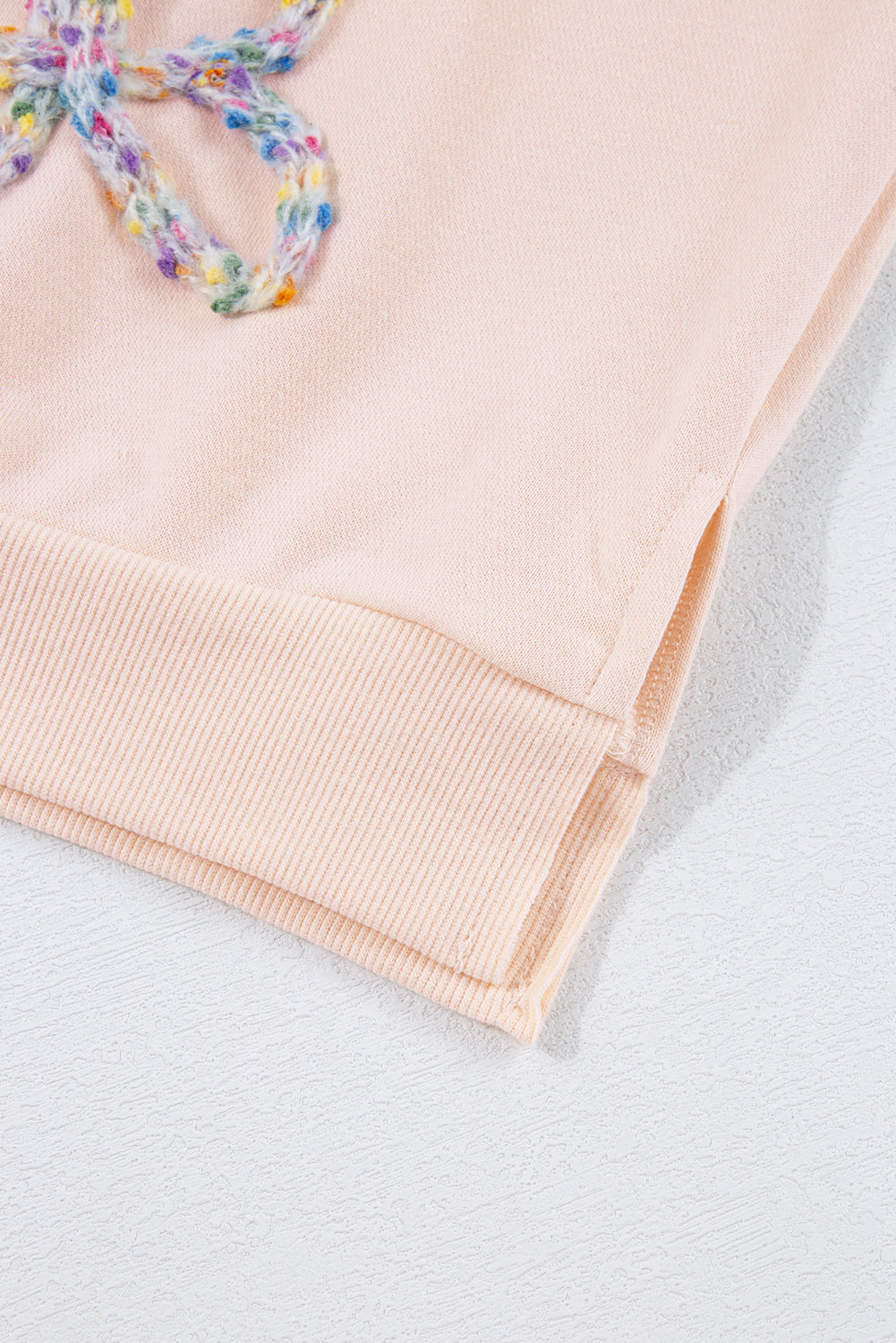 Mommas Hive oversized sweatshirt with parchment color, embroidered bow detail, lantern sleeves, made of polyester and cotton.