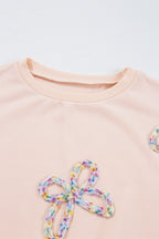 Mommas Hive oversized sweatshirt with parchment color, embroidered bow, lantern sleeves, made of polyester and cotton, casual style.