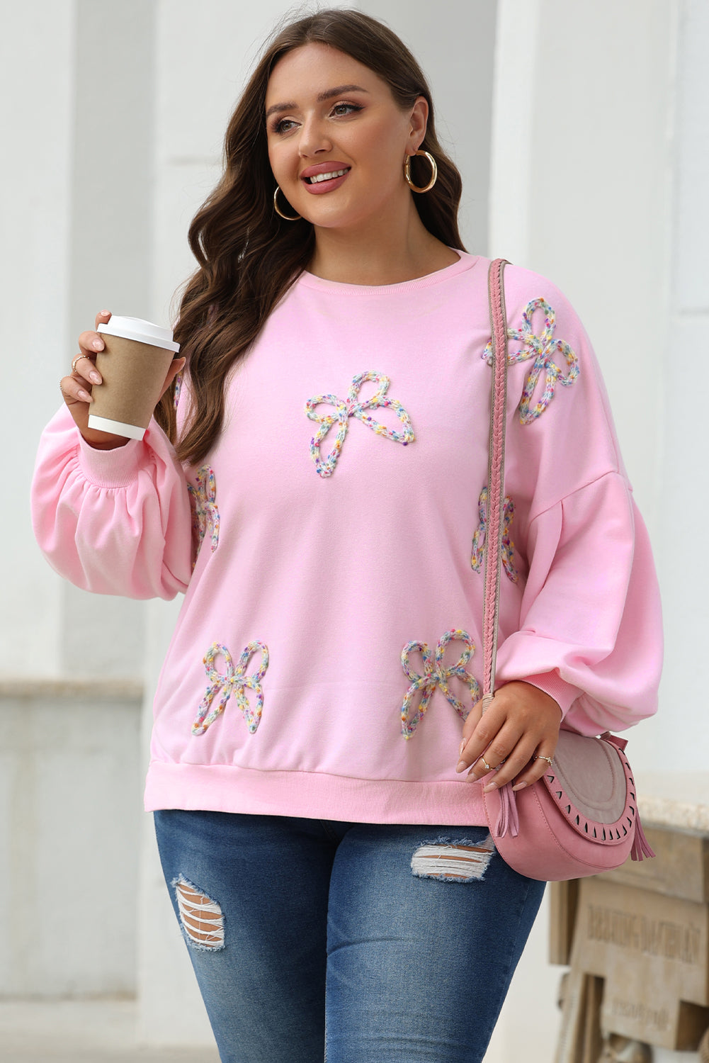 Mommas Hive oversized sweatshirt with parchment-colored fabric, embroidered bow detail and lantern sleeves, casual pullover style.