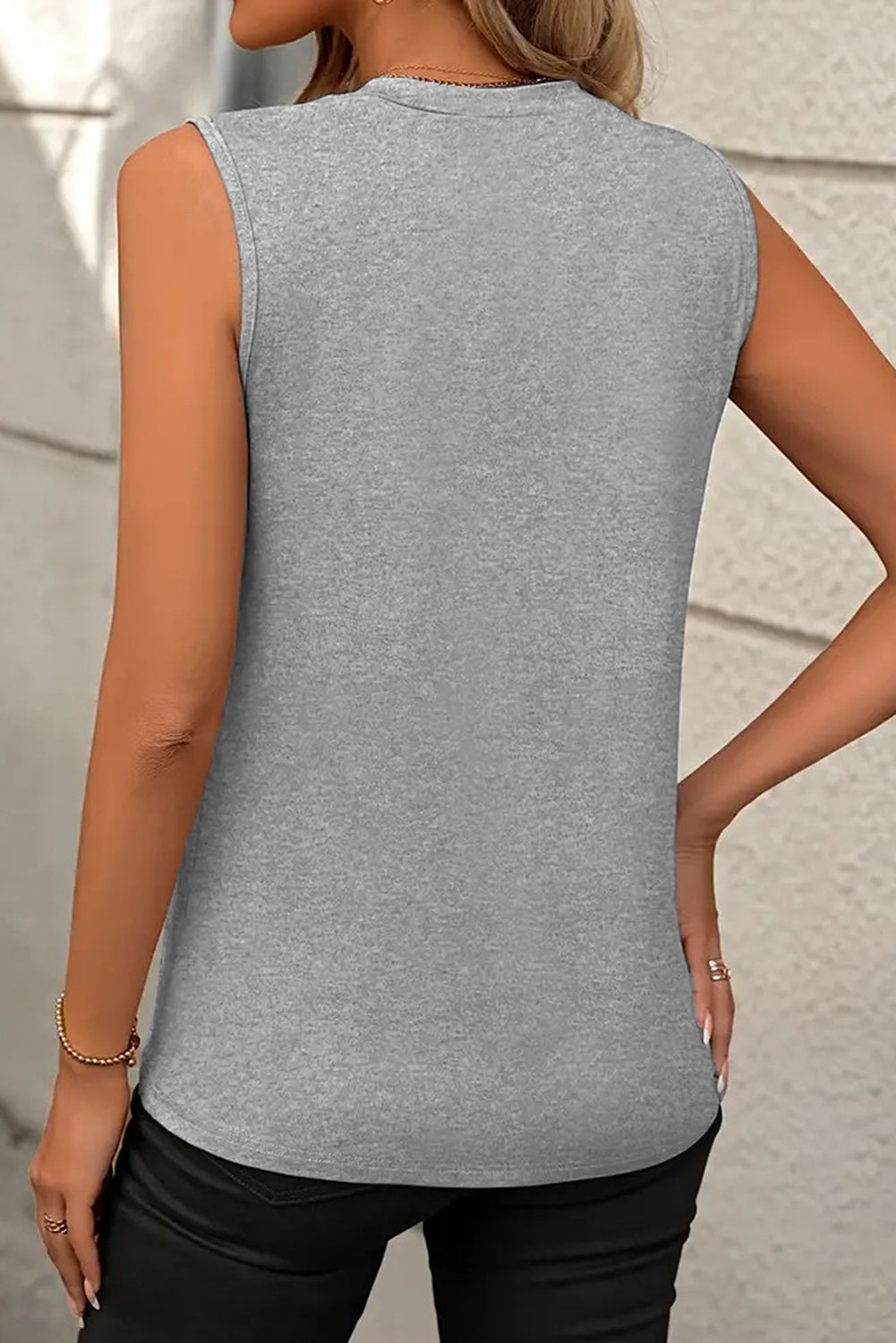 White crew neck pleated tank top from Mommas Hive, made of polyester, cotton, and elastane, shown on a hanger.