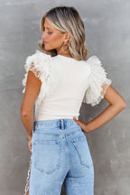 White Dotty Mesh Ruffle Sleeve Ribbed Knit Top by Mommas Hive, featuring lightweight knit fabric with ruffle sleeves and a dotted mesh design.