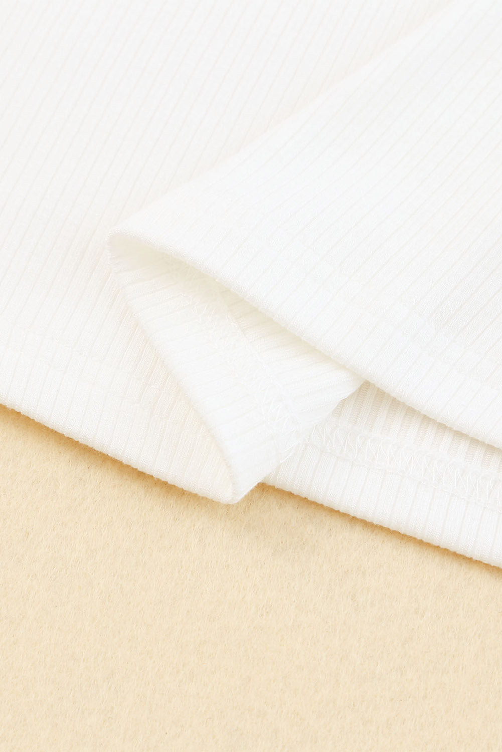 White dotty mesh ruffle sleeve ribbed knit top by Mommas Hive, featuring lightweight fabric and stylish ruffle details.