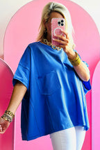 Blue oversized T-shirt from Mommas Hive featuring patched pockets and exposed seams, made of polyester, cotton, and elastane blend.