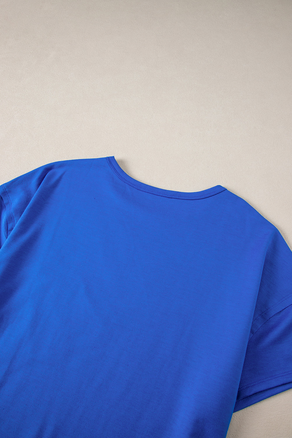 Blue oversized T-shirt by Mommas Hive with patched pocket and exposed seams, made from polyester, cotton, and elastane.