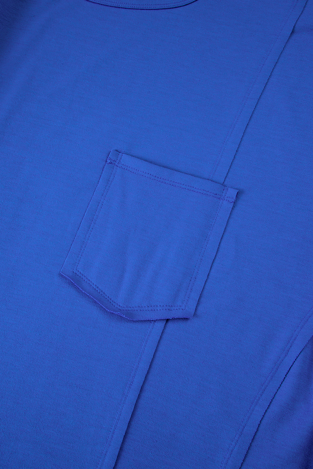 Blue oversized T-shirt by Mommas Hive with patched pocket and exposed seam, made of polyester, cotton, and elastane.